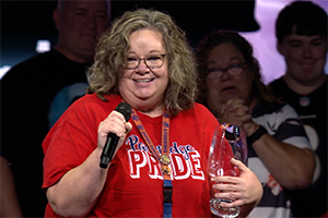 Theresa Maitner celebrates on stage after winning award